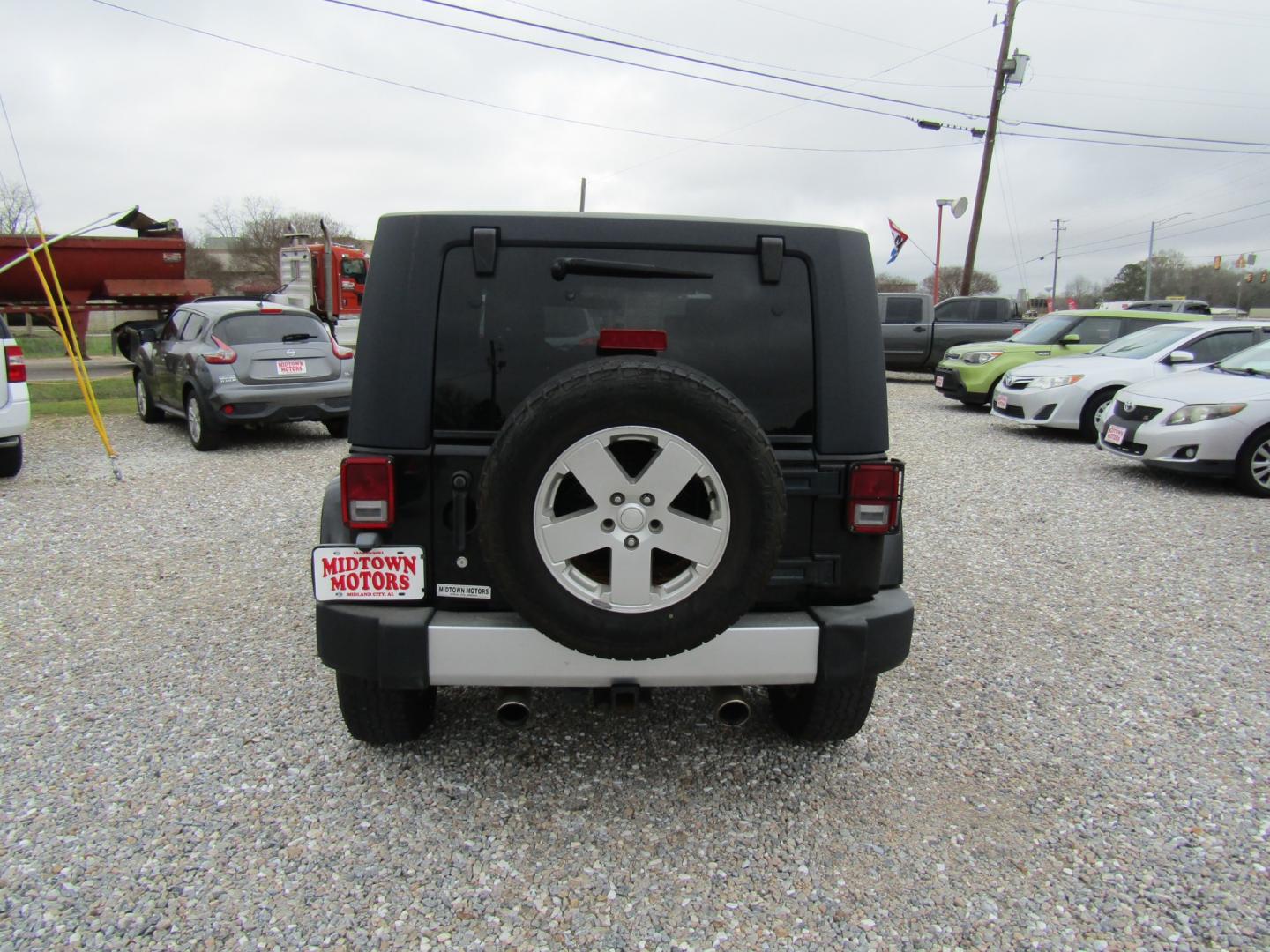 2008 Black Jeep Wrangler Unlimited Sahara 4WD (1J4GA591X8L) with an 3.8L V6 OHV 12V engine, Automatic transmission, located at 15016 S Hwy 231, Midland City, AL, 36350, (334) 983-3001, 31.306210, -85.495277 - Photo#6